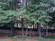 Level landscaped back yard with privacy fence in wooded setting at 200 Chaparral Trce, Tyrone, GA 30290