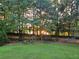 Green backyard with mature trees and sunshine at 200 Chaparral Trce, Tyrone, GA 30290