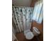 A cozy bathroom features a toilet and leafy shower curtain at 200 Chaparral Trce, Tyrone, GA 30290