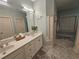 Bright bathroom with double sinks, a framed mirror and vanity, with two entry door and walk through access at 200 Chaparral Trce, Tyrone, GA 30290