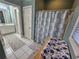 A simple bathroom featuring a toilet and shower with flower curtain at 200 Chaparral Trce, Tyrone, GA 30290