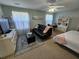 Bright bedroom featuring a bed, sofa, desk, and media area for relaxation and productivity at 200 Chaparral Trce, Tyrone, GA 30290