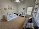 Well-lit Bedroom featuring a daybed, crib, and cozy seating area with decorative nautical accents at 200 Chaparral Trce, Tyrone, GA 30290