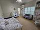 Bedroom with a crib and a comfortable sofa, bathed in natural light and with built-in shelving at 200 Chaparral Trce, Tyrone, GA 30290
