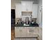 Well-organized coffee bar area with white cabinets, countertop appliances, and a decorative sign at 200 Chaparral Trce, Tyrone, GA 30290