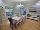 Bright dining room featuring large windows, a chandelier, hardwood floors, and wainscoting at 200 Chaparral Trce, Tyrone, GA 30290
