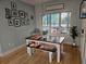 Charming dining area with a wooden table, bench seating, and a large window with natural light at 200 Chaparral Trce, Tyrone, GA 30290