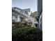Exterior view showcases home's architecture, outdoor staircase, and lush greenery, creating a private setting at 200 Chaparral Trce, Tyrone, GA 30290