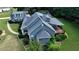 An aerial view of the rear of a charming blue home and its deck and landscaped back yard at 200 Chaparral Trce, Tyrone, GA 30290