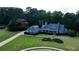 Sprawling property with manicured lawns, a detached garage, and a beautiful home with a welcoming front porch at 200 Chaparral Trce, Tyrone, GA 30290