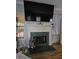 Stylish fireplace with a black marble hearth, a decorative mantle, and a large screen television at 200 Chaparral Trce, Tyrone, GA 30290
