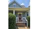 Inviting front porch with classic columns, stylish lighting, and well-maintained landscaping for great curb appeal at 200 Chaparral Trce, Tyrone, GA 30290