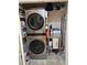 A laundry room features a stackable washer and dryer, and shelving at 200 Chaparral Trce, Tyrone, GA 30290