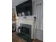 Cozy living room features a decorative fireplace with a large television mounted above it at 200 Chaparral Trce, Tyrone, GA 30290