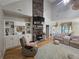 Open-concept living room boasts a stone fireplace, built-in shelves, and hardwood flooring throughout at 200 Chaparral Trce, Tyrone, GA 30290