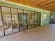 Covered patio with screen and wooden flooring, ideal for outdoor enjoyment and entertaining at 200 Chaparral Trce, Tyrone, GA 30290