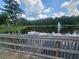 Scenic pond with a fountain, reflecting the sky, as seen from a wooden bridge at 200 Chaparral Trce, Tyrone, GA 30290
