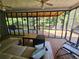 Screened porch with wooden floors, a ceiling fan, and lounge furniture at 200 Chaparral Trce, Tyrone, GA 30290