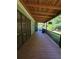 Spacious wooden porch with cover and railing overlooking backyard at 200 Chaparral Trce, Tyrone, GA 30290