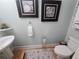 Charming powder room showcasing a pedestal sink, toilet, and tasteful coastal-themed decor accents at 200 Chaparral Trce, Tyrone, GA 30290