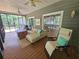 Inviting sunroom with comfortable seating, ceiling fans, and screened windows offering scenic outdoor views at 200 Chaparral Trce, Tyrone, GA 30290