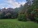 Landscaped yard featuring flowering trees and lush greenery at 200 Chaparral Trce, Tyrone, GA 30290