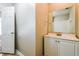 Bright bathroom featuring a white vanity, a large mirror, and a door to the bedroom/hallway at 3163 Springside Xing, Decatur, GA 30034