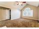 Bright bedroom featuring carpet, ceiling fan, vaulted ceiling and large window at 3163 Springside Xing, Decatur, GA 30034
