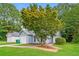 Landscaped front yard of a well-maintained single-story home with mature tree at 3163 Springside Xing, Decatur, GA 30034