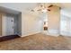 Neutral living room showcasing access to the kitchen, vaulted ceilings, carpet, and fireplace at 3163 Springside Xing, Decatur, GA 30034