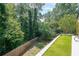 View of the well-maintained backyard, surrounded by lush trees and a wood fence, offering privacy and tranquility at 503 Rising Dr, Woodstock, GA 30189