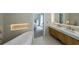 Elegant bathroom featuring a soaking tub, modern vanity, and view to main bedroom at 503 Rising Dr, Woodstock, GA 30189