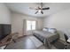 Cozy bedroom with a ceiling fan, natural light, and a functional workspace at 503 Rising Dr, Woodstock, GA 30189