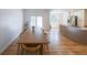 Open dining area connected to a modern kitchen, featuring hardwood floors and ample natural light at 503 Rising Dr, Woodstock, GA 30189