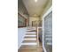 Welcoming foyer with hardwood stairs, black iron railing, and decorative glass front door at 503 Rising Dr, Woodstock, GA 30189