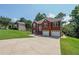 A brick-fronted home with a two-car garage, a well-maintained lawn, and a classic arched entryway at 503 Rising Dr, Woodstock, GA 30189