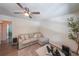 Inviting living room featuring a ceiling fan, comfortable seating, and stylish decor at 503 Rising Dr, Woodstock, GA 30189