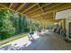View of the large, covered back patio, perfect for outdoor dining and relaxing, overlooking the wooded backyard at 503 Rising Dr, Woodstock, GA 30189