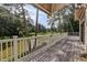 Large back deck with white railing overlooking lush greenery and waterfront view at 1530 Niskey Lake Sw Trl, Atlanta, GA 30331