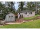 Backyard guest house with outdoor storage, surrounded by greenery and steps to a deck at 1530 Niskey Lake Sw Trl, Atlanta, GA 30331