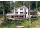 Backyard view of the house with a deck, stone patio, and landscaped yard at 1530 Niskey Lake Sw Trl, Atlanta, GA 30331