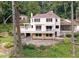 Backyard view of the house with a deck, stone patio, and landscaped yard at 1530 Niskey Lake Sw Trl, Atlanta, GA 30331