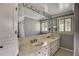 Bright bathroom featuring dual sinks, neutral-toned counters, and a large mirror, for a bright and functional space at 1530 Niskey Lake Sw Trl, Atlanta, GA 30331
