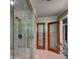 Modern bathroom with tiled shower and wooden doors at 1530 Niskey Lake Sw Trl, Atlanta, GA 30331