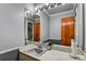 Cozy powder room featuring a single sink vanity with a large mirror, ideal for guests and convenient access at 1530 Niskey Lake Sw Trl, Atlanta, GA 30331