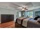 This bedroom features hardwood floors, a decorative ceiling, and a ceiling fan at 1530 Niskey Lake Sw Trl, Atlanta, GA 30331