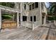 Spacious wooden deck featuring a hot tub, white railing, and awning, perfect for outdoor relaxation and entertainment at 1530 Niskey Lake Sw Trl, Atlanta, GA 30331
