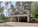 Charming two-story home with a carport and a landscaped yard surrounded by lush greenery and mature trees at 1530 Niskey Lake Sw Trl, Atlanta, GA 30331