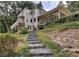 Charming two-story home with a deck, screened in porch, stone steps, and lush landscaping at 1530 Niskey Lake Sw Trl, Atlanta, GA 30331