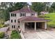 Charming two-story home with a carport and a landscaped yard surrounded by lush greenery and mature trees at 1530 Niskey Lake Sw Trl, Atlanta, GA 30331